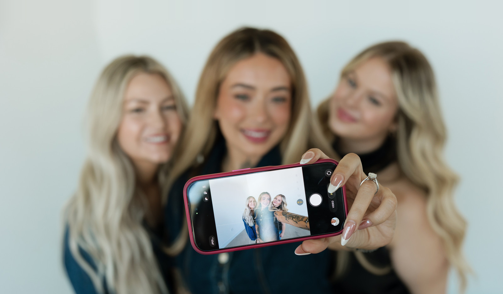 Three Socialite stylists taking a selfie together