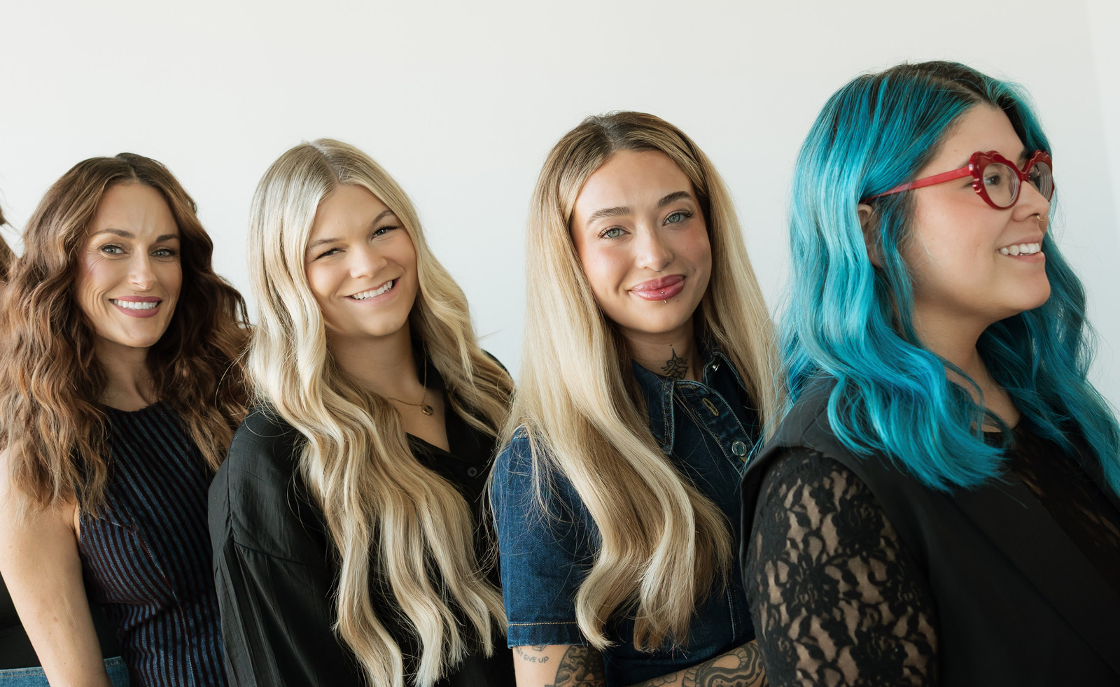 Four Socialite stylists smiling side by side