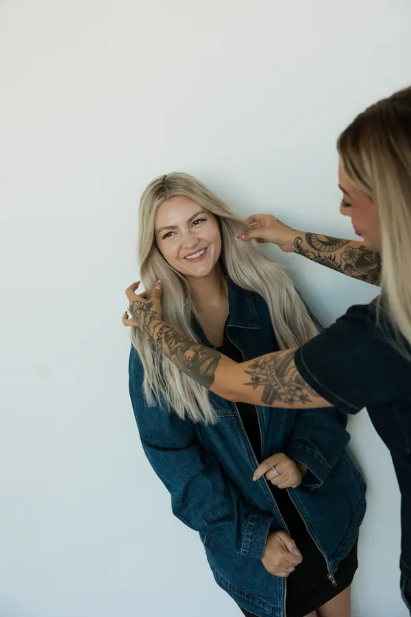 Stylist laughing while her hair is styled