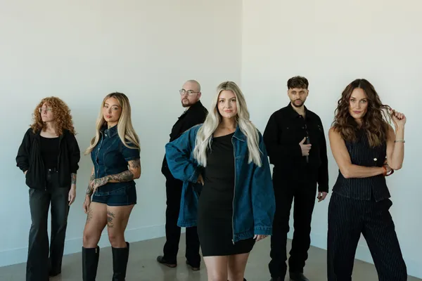 Socialite stylists standing in a row