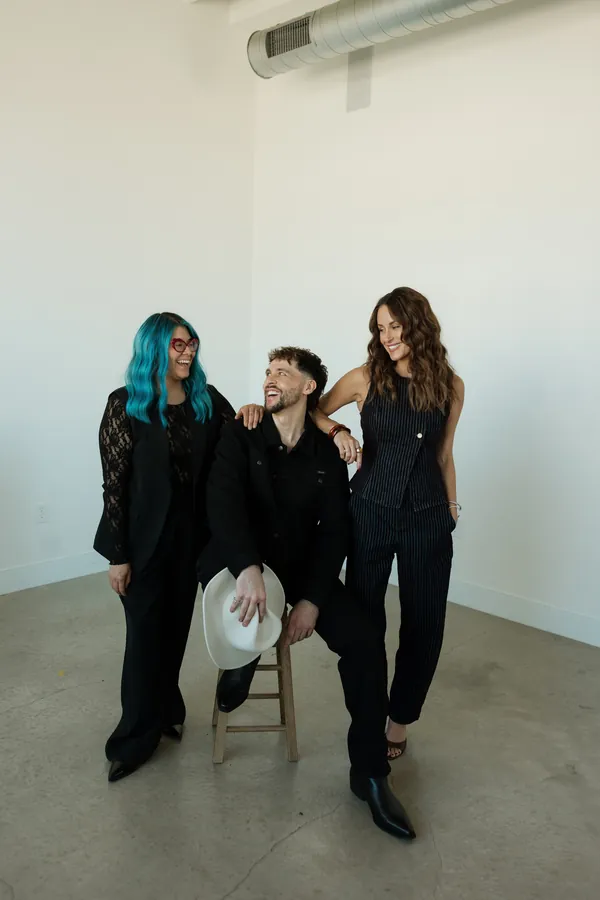 Three stylists posing together in the studio