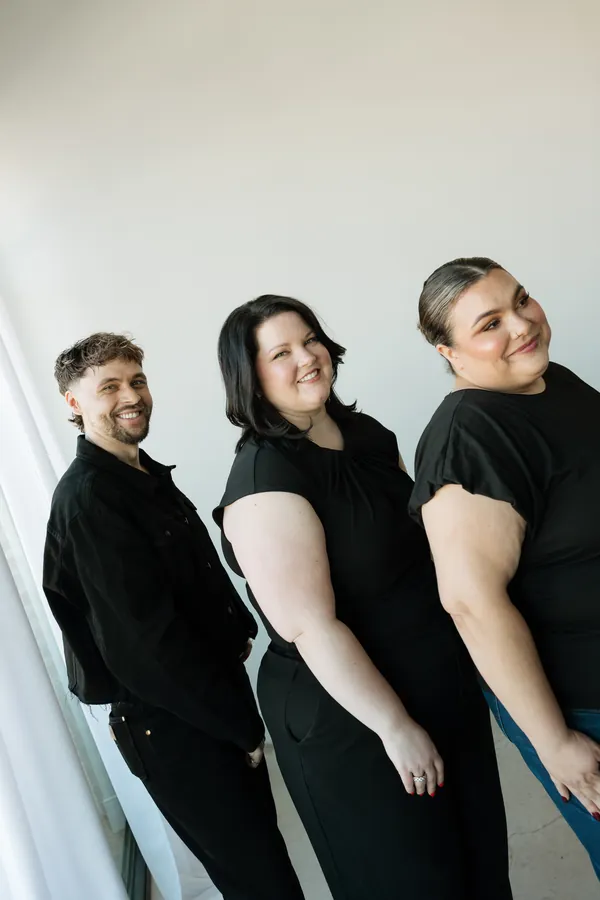 Three stylists posing in a row